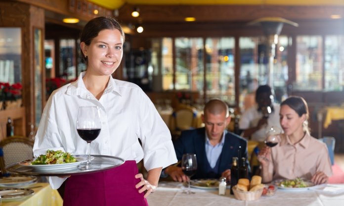 Portrait,Young,Waitress,Standing,Holding,Tray,With,Salad,And,Wine,